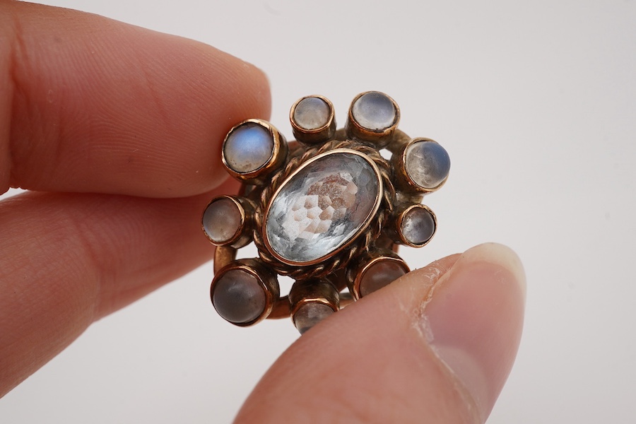 A yellow metal single stone aquamarine and nine stone cabochon moonstone set oval cluster ring, size R, gross weight 7.8grams Condition - poor to fair